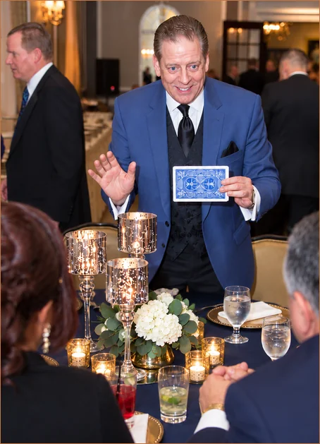 Mike performing close-up card magic for guests