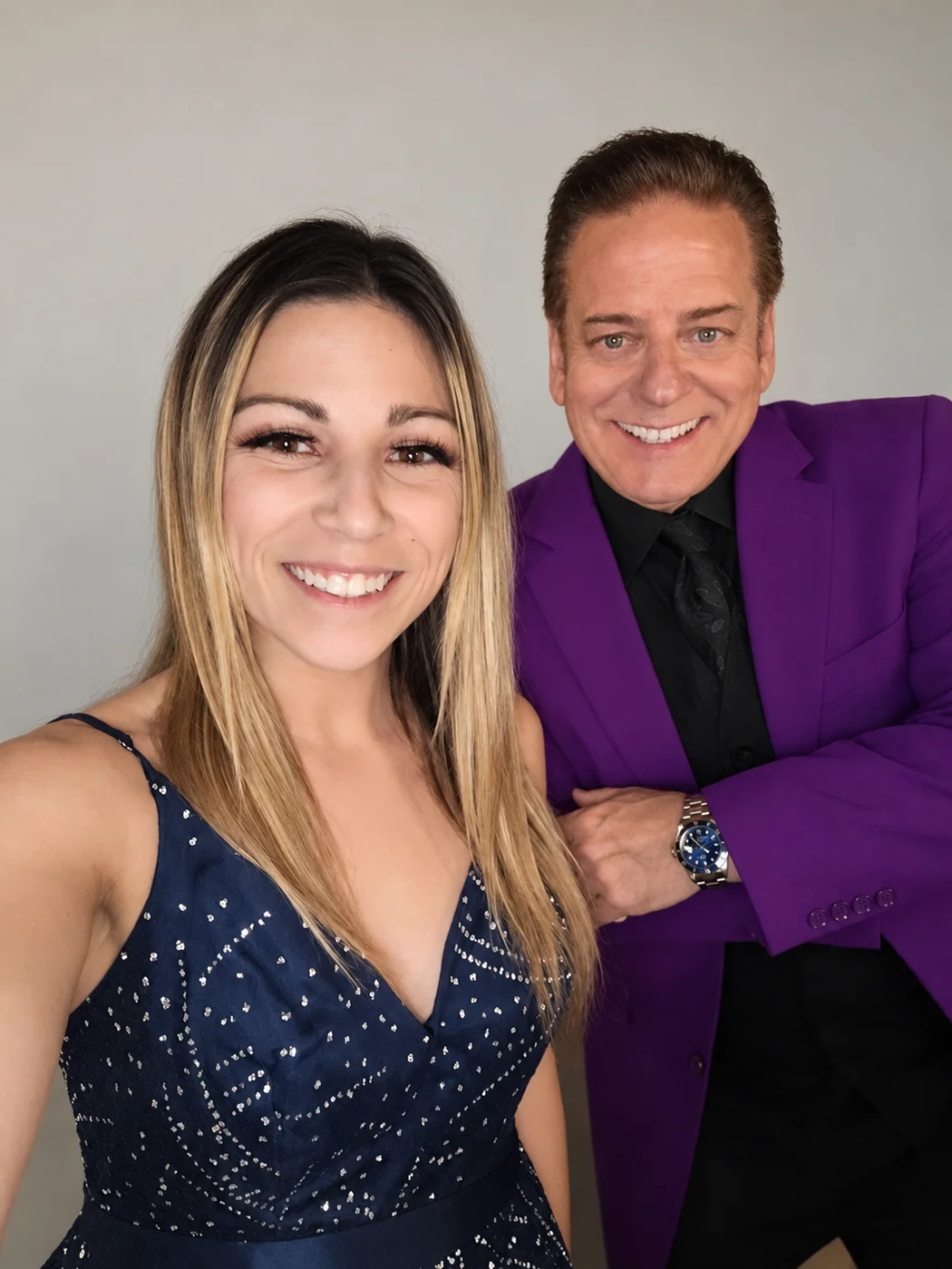 Mike Thornton in a purple jacket smiling with an event guest